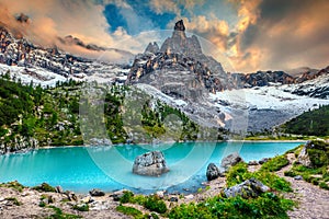 Amazing alpine landscape with turquoise glacier lake, Sorapis, Dolomites, Italy photo