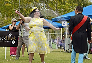 Confident, flamboyant, fun, happy plus-size woman modelling at dog show