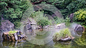 Wonderful lake with clear water surrounded by rocks and trees with rocks and reflections in the water in the natural park of seoul