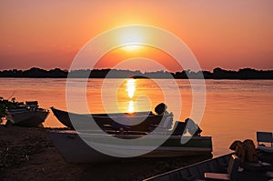 Wonderful landscape of a silhouette of boats on a amazing sunset