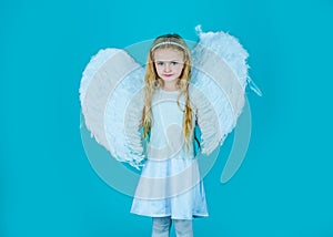 Wonderful little girl angel with white wings. Little angel Girl in white dress with angel wings on isolated background.