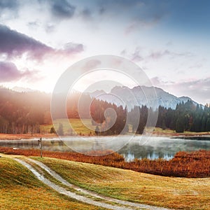 Wonderful misty landscape at Germanian Alps. Colorful Clouds on Blue Sky over the Karwendel mountains at early morning in autumn,