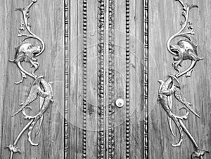 Wonderful old italian door carved on wood with golden dragons.