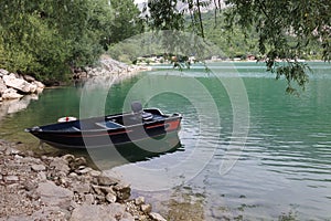 Wonderful panorama of the lake of Scanno with a blue boat. photo