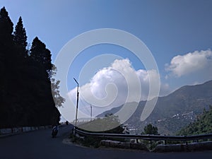 A  wonderful panoramic scene of green hills with clouds in blue sky