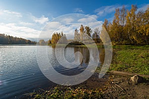 Wonderful picturesque Scene. Awesome Autumn landscape with colorful sky, reflected on the calm river. Amazing nature counryside. I