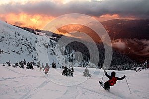 Wonderful picturesque scene of mountain landscape and freeride skiers descends from slope