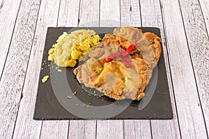 Wonderful plate of Asturian veal cachopo with ham and cheese battered in flour, egg and breadcrumbs photo
