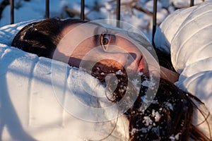 Wonderful portrait of an attractive, young, sexy, seductive dark brown haired woman in Bed, snowflakes on her long hair