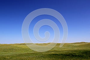 Wonderful prairie background - beautiful grass hills and a clear blue sky photo