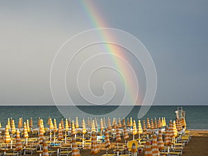 Wonderful rainbow over the Adriatic sea. Contrast between the bright colors of the rainbow and the green sea