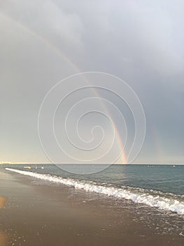 Wonderful rainbow over the sea and the beach in Turkey after heavy rain