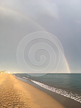 Wonderful rainbow over the sea and the beach in Turkey after heavy rain