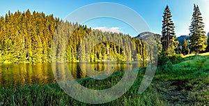 Wonderful summer morning. majestic mountain lake in mountain. Lakul Rosu - Red Lake or Lake Killer. The location of Europe. Easter photo