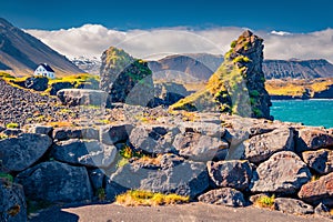 Wonderful summer scenery. Sunny morning view of small fishing village at the foot of Mt. Stapafell - Arnarstapi or Stapi. photo