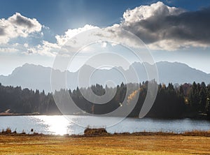 Wonderful sunny landscape. Fantastic Bavarian Alps with Geroldsee lake under sunlight. Perfect sky glowing in sunlit, reflected in