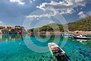 Wonderful Sunny seascape. boats in beautiful turquoise ocean near an island. Amazing Coastline with Colorful Houses