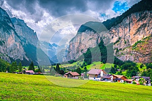 Wonderful touristic alpine village with summer green fields, Lauterbrunnen, Switzerland