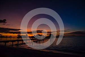 Wonderful tropical sunset, jetty, palm tree, Maldives photo