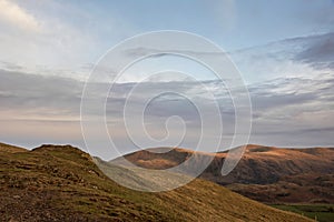 Wonderful vibrant sunset landscape image of view from Latrigg Fell towards Great Dodd and Stybarrow Dodd in Lake District