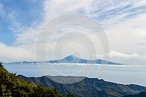 Wonderful views of the island of Tenerife and the Teide from the viewpoint of the Laja in the haze of the summits in La Gomera.