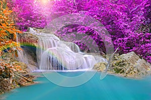 Wonderful Waterfall with rainbows in deep forest at national park photo