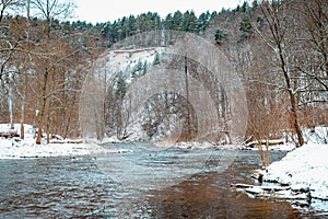 Wonderful winter landscape with frozen lake and pine trees forest