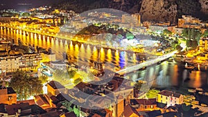Wonderfull aerial panoramic view of Old Town Omis , Cetina river and mountains at night