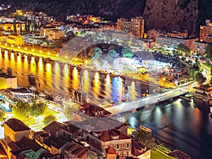 Wonderfull aerial panoramic view of Old Town Omis , Cetina river and mountains at night