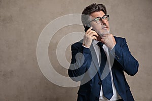 Wondering businessman talking on his mobile