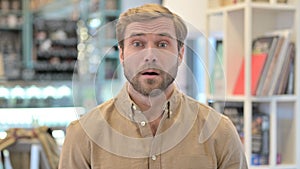 Wondering Young Man in Shock Looking at Camera