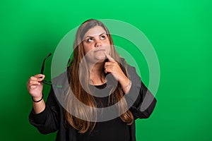 Wondering, Young woman, wearing black glasses on Green Background