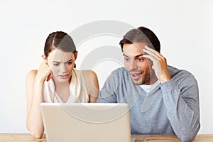 The wonders of the web. A handsome man and a beautiful young woman working together on a laptop.