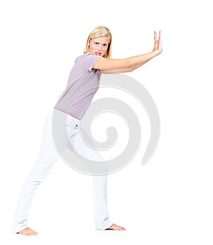 This wont budge. Pretty young woman pushing a object to the right - Isolated on white.