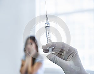 This wont hurt a bit..I promise. A doctor preparing to give a nervous young woman an injection.