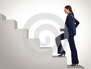 She wont stop still she gets to the top. Studio shot of a motivated businesswoman climbing a flight of stairs.