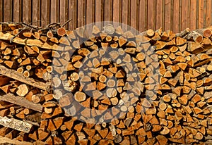 Wood abstract background. Texture f dry firewood pile for furnace kindling. Chopped firewood logs. Firewood stack.