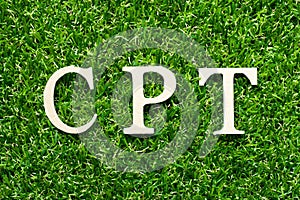 Wood letter in word CPT Abbreviation of Carriage Paid To on green grass background