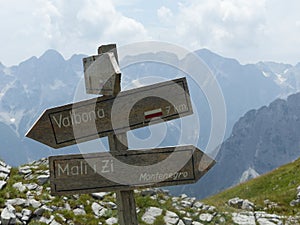 Wood arrows paths indications in the Albanian Alps.