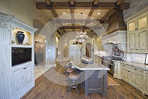 Wood Beamed Ceiling With Stools At Kitchen Island