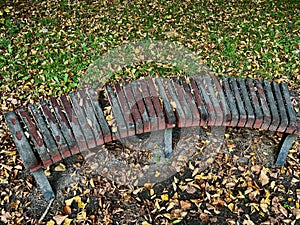 Wood bench in autumn park Duchcov. Autumn landscape. Hand-painted colorful stone on bench