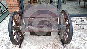 Wood bench with cart wheels