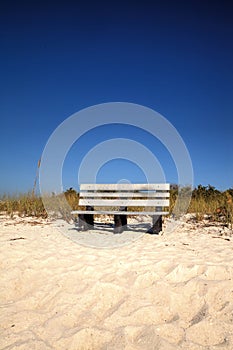 Wood bench on the white sand beach of Delnor-Wiggins Pass State photo