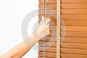 Wood blinds closed by hand.