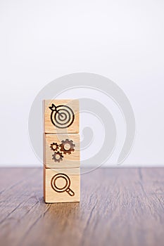 Wood block with business goal, strategy, target, mission, action, objective, teamwork, brainstorm and idea concept