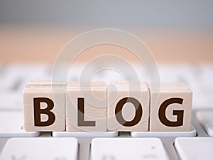 Wood block cube on computer keyboard with word BLOG