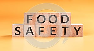 Wood block with food safety on yellow background