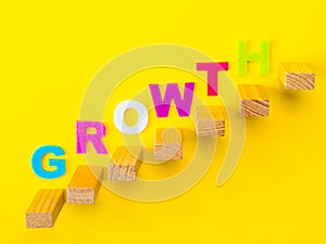 Wood block stacking as step stair with colorful of `GROWTH` word