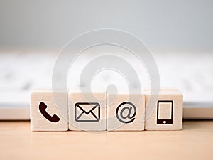 Wood block symbol telephone, mail, address and mobile phone. Website page contact us or e-mail marketing concept