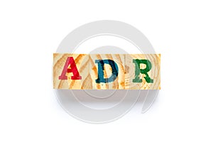 Wood block in word ADR Abbreviation of adverse drug reaction on white background